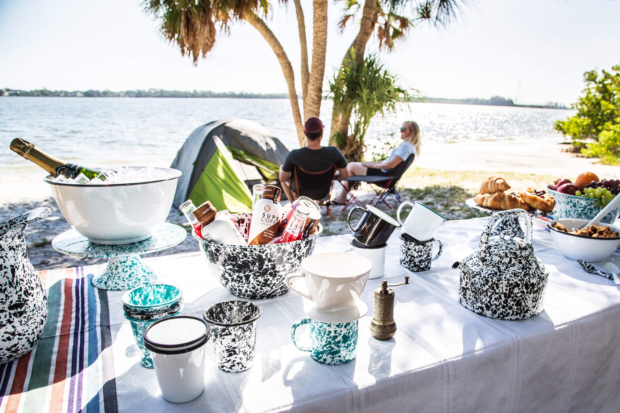 enamelware and tablecloth at camping breakfast picnic table